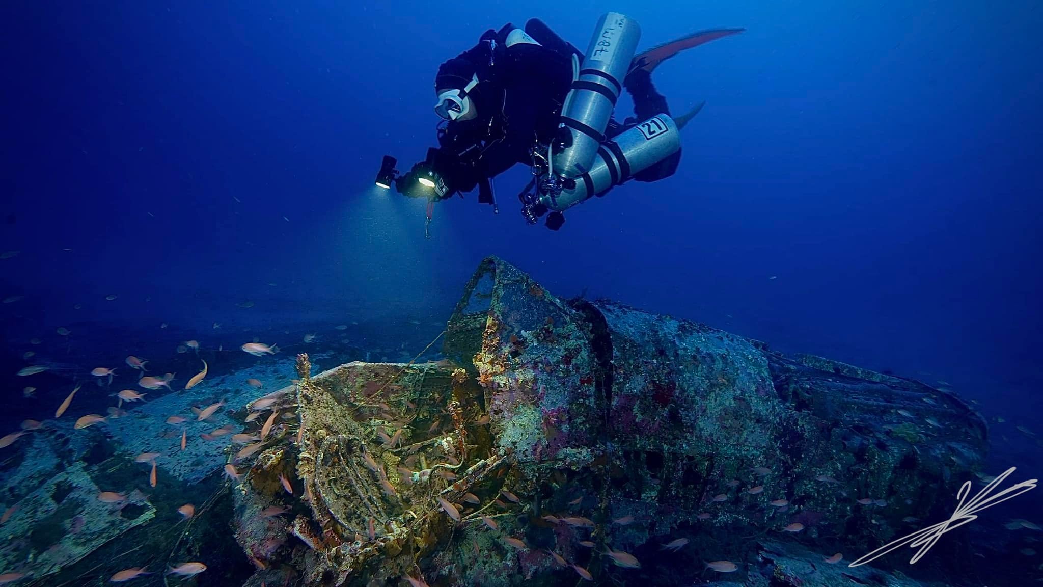 technical diver taking photo of a wreck